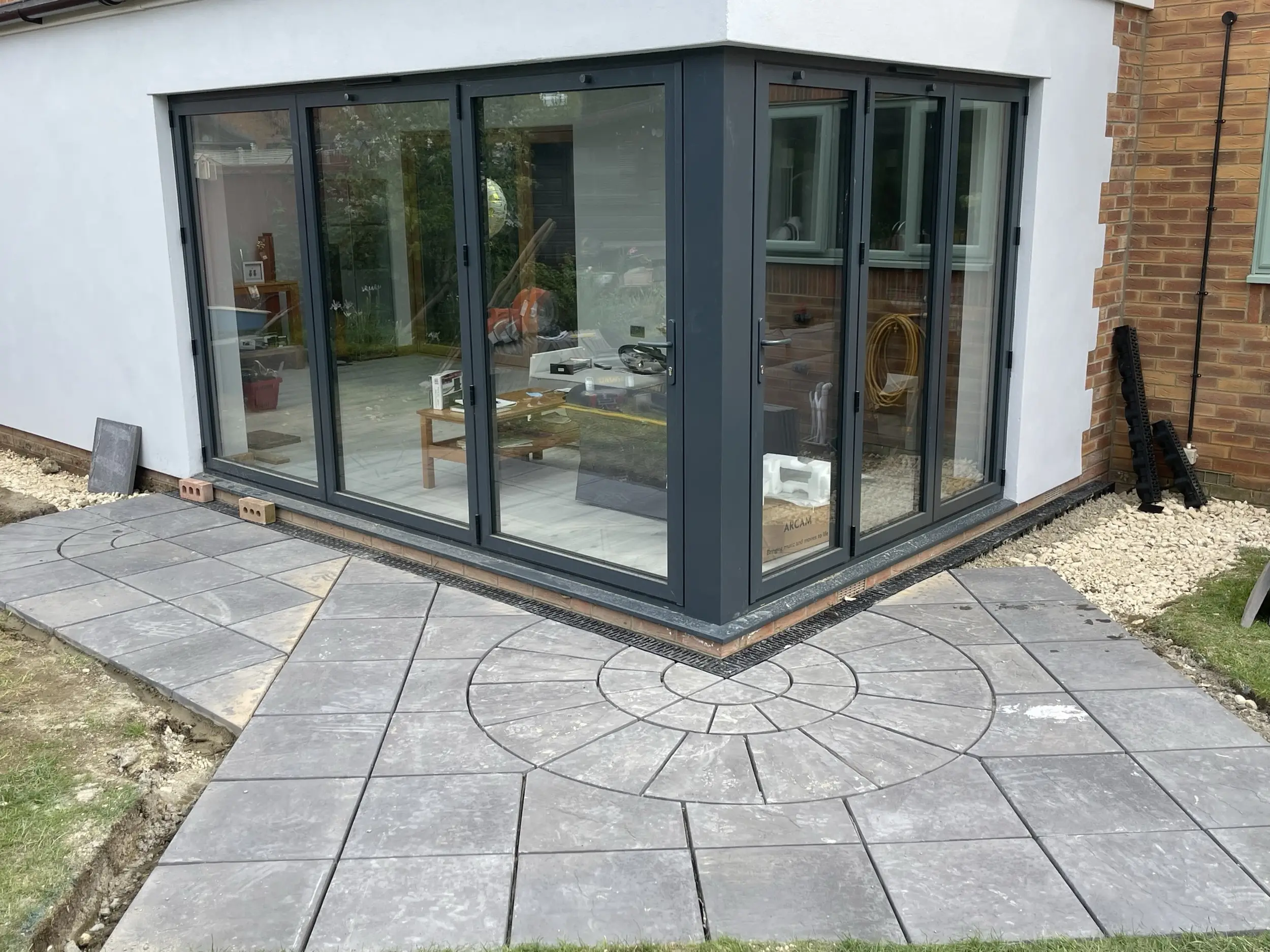 Corner glazed extension and circular patio completed by Ablewood