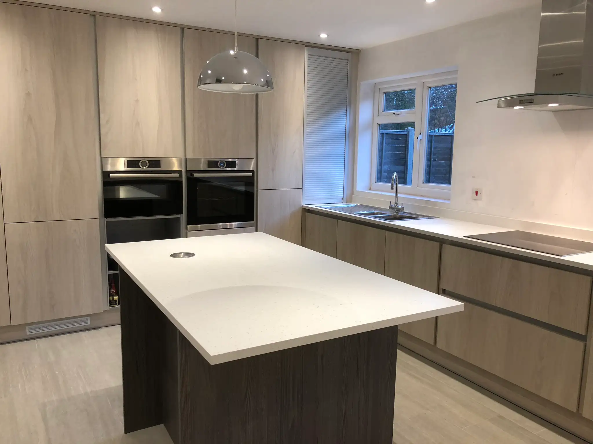 Light oak kitchen with a stone topped island