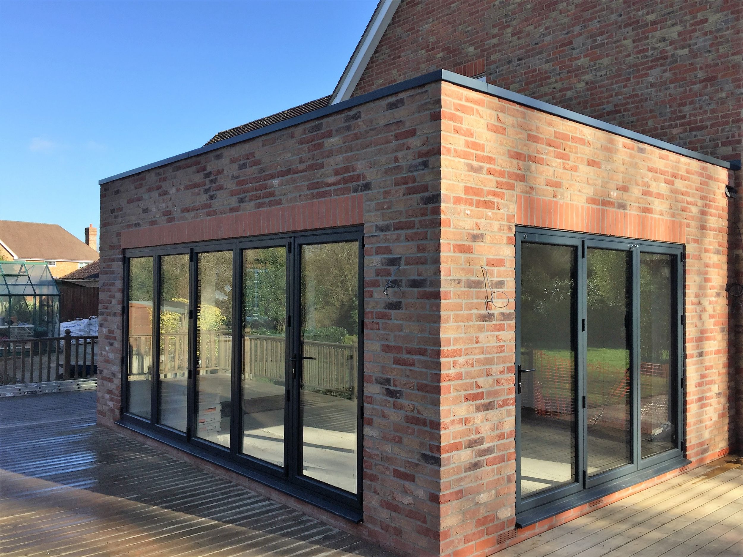 Brick garden room with bi-fold doors and decking
